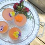 Vodka Aperol Tangerine Lime Cocktail with Edible pansies