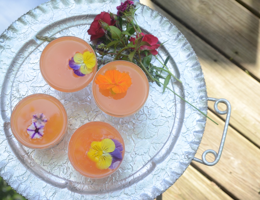 Vodka Aperol Tangerine Lime Cocktail with Edible pansies