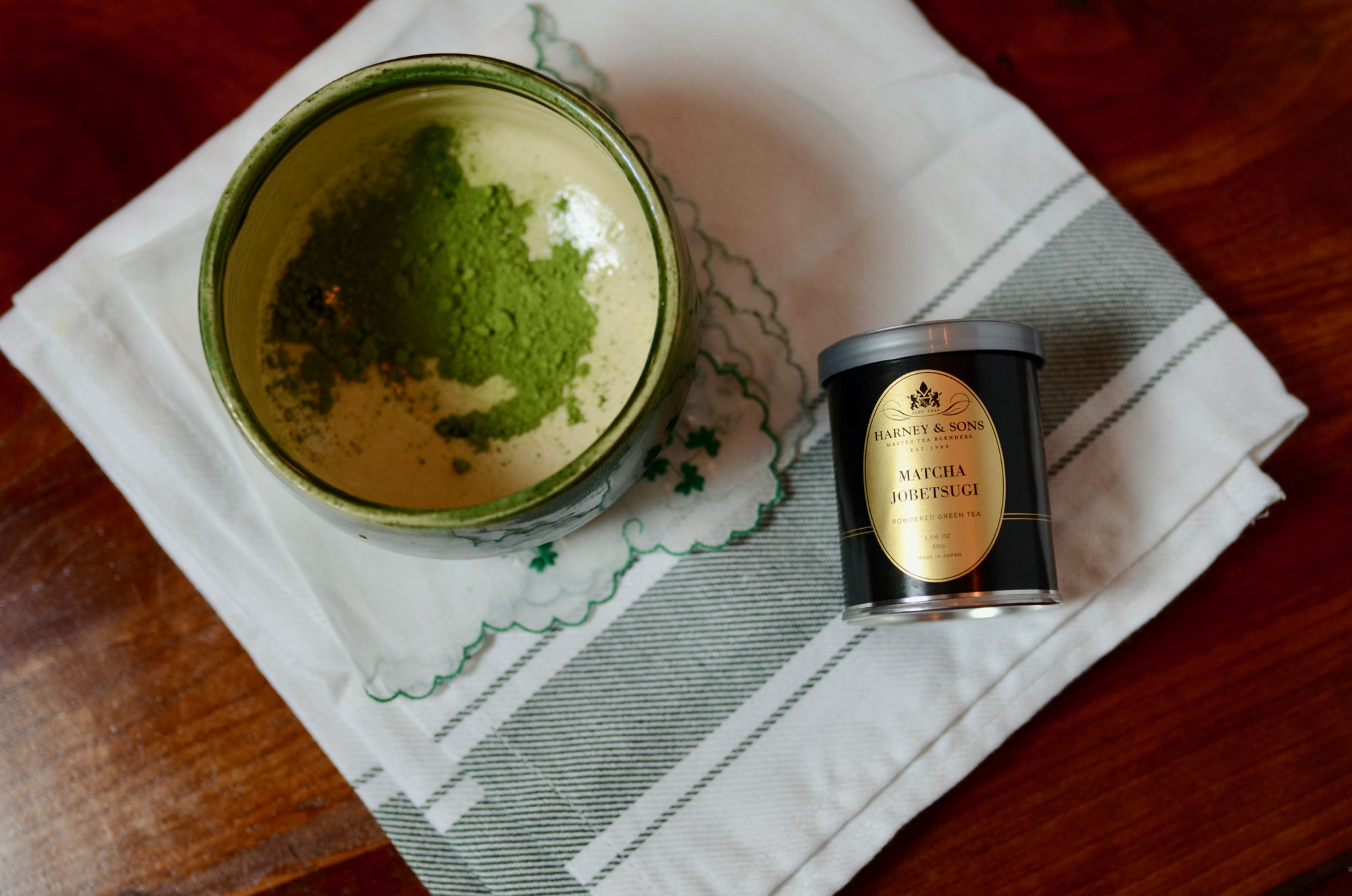 Green matcha powder in a ceramic bowl